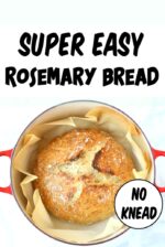 Baked loaf of no knead rosemary artisan bread in dutch oven.