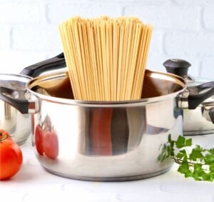 Fettuccine alfredo noodles in pot.