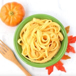 Pumpkin pasta in bowl with fork to the side.