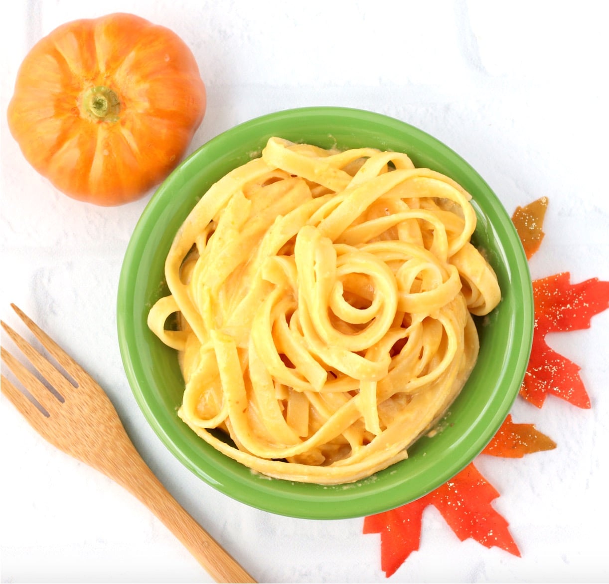 Pumpkin pasta in bowl with fork to the side.