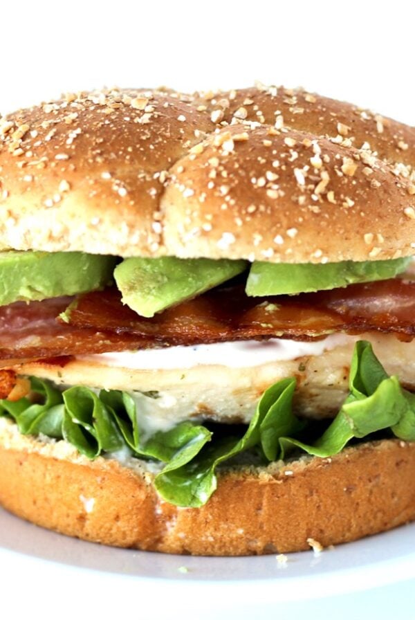Grilled California chicken sandwich with ranch, bacon, and avocado slices on bun.