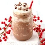 Frozen Hot Chocolate in mason jar with whip cream and chocolate curls on top.