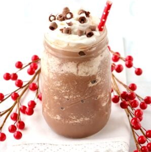 Frozen Hot Chocolate in mason jar with whip cream and chocolate curls on top.