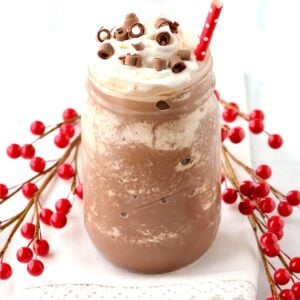 Frozen Hot Chocolate in mason jar with whip cream and chocolate curls on top.