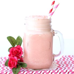 Pink punch in mason jar mug with straws.