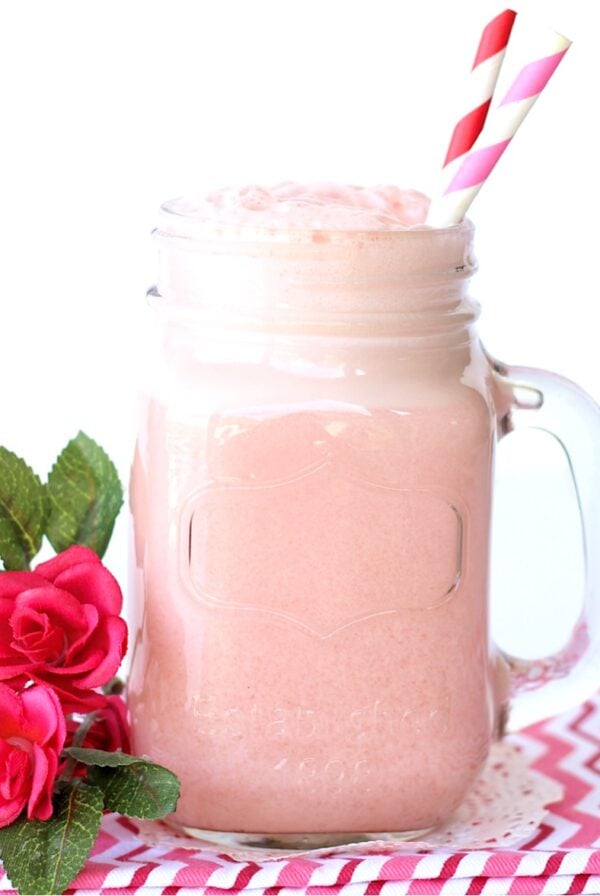 Pink punch in mason jar mug with straws.