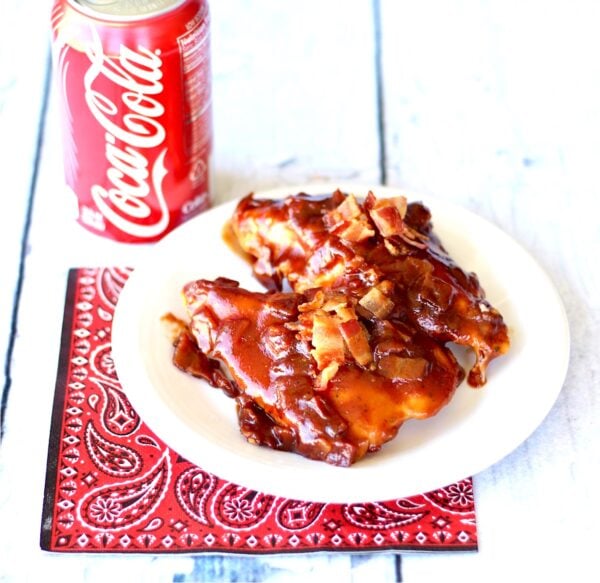 BBQ Chicken on plate with crispy bacon on top.