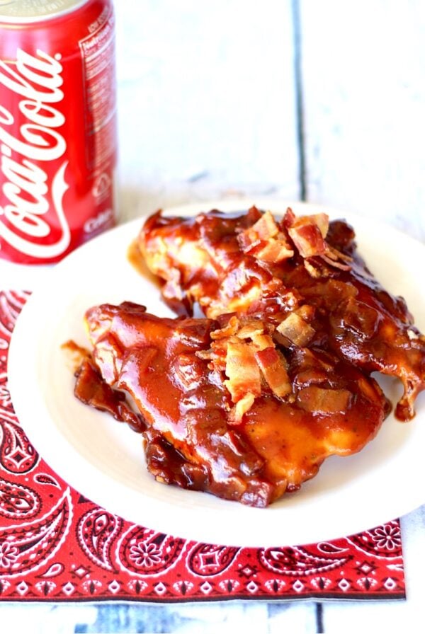 BBQ Chicken on plate with crispy bacon on top.