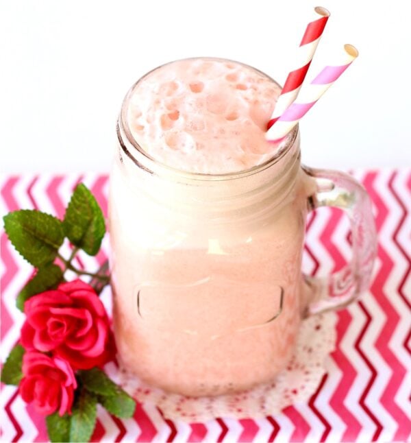 Pink punch in mason jar mug with straws.