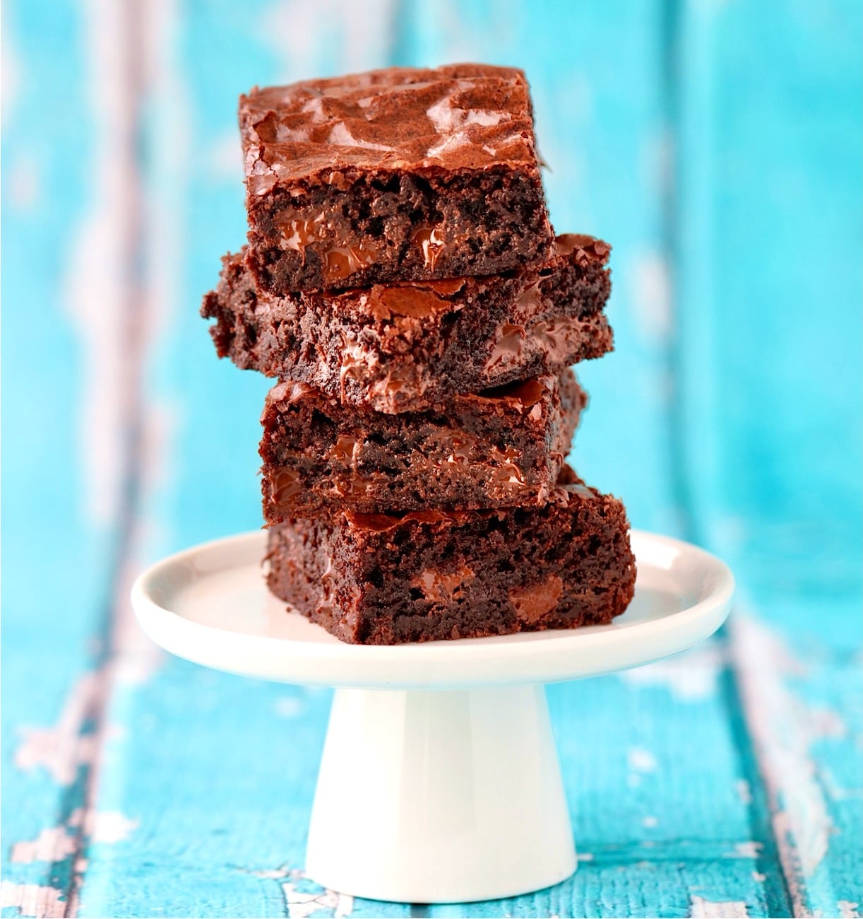 Stack of four chocolate chip brownies.