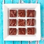 Nine chocolate chip brownies on plate.