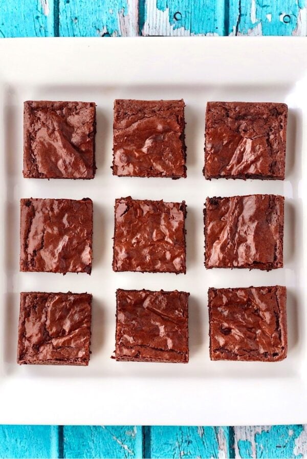 Nine chocolate chip brownies on plate.