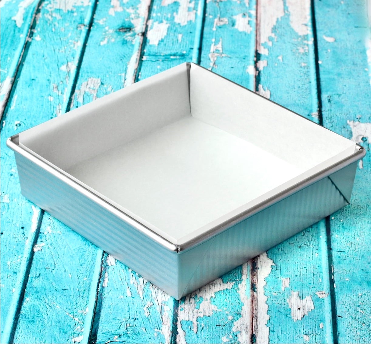 8x8 Metal Brownie Pan lined with Parchment Paper.