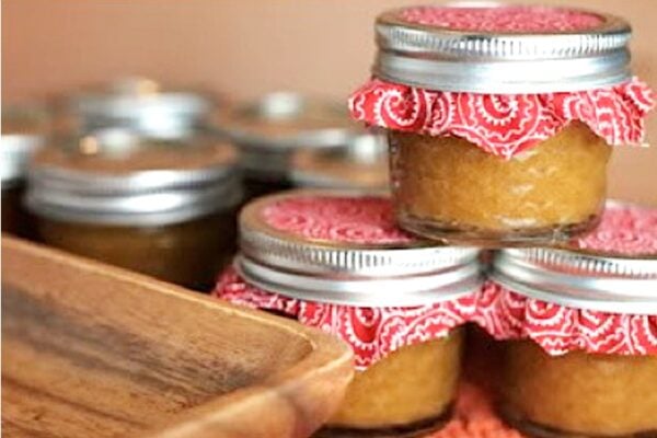 Three small mason jars filled with peach butter.