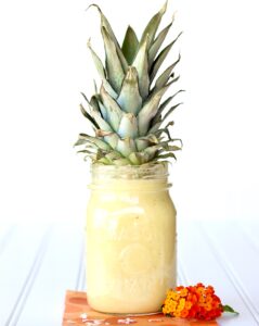 Pineapple Milkshake in mason jar with pineapple top.