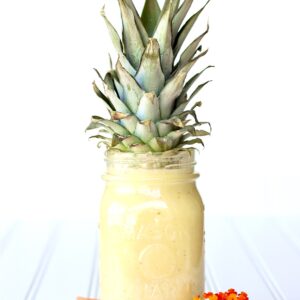 Pineapple Milkshake in mason jar with pineapple top.