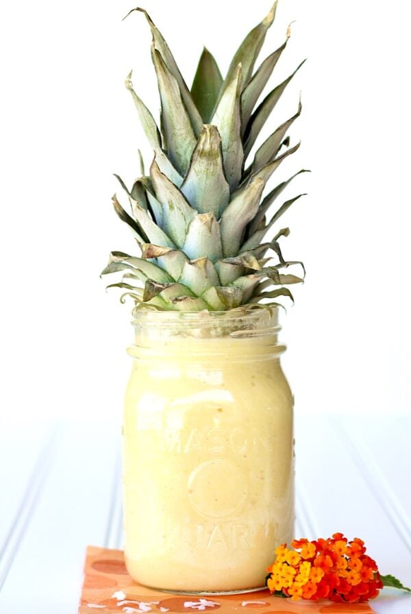 Pineapple Milkshake in mason jar with pineapple top.
