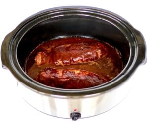 Pork tenderloin in slow cooker with barbecue sauce.
