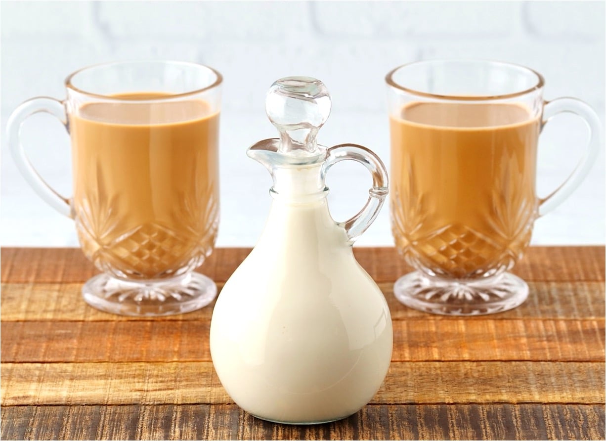 Homemade coffee creamer with two mugs of coffee.