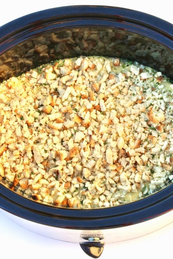 Chicken and stuffing casserole cooking in crockpot.