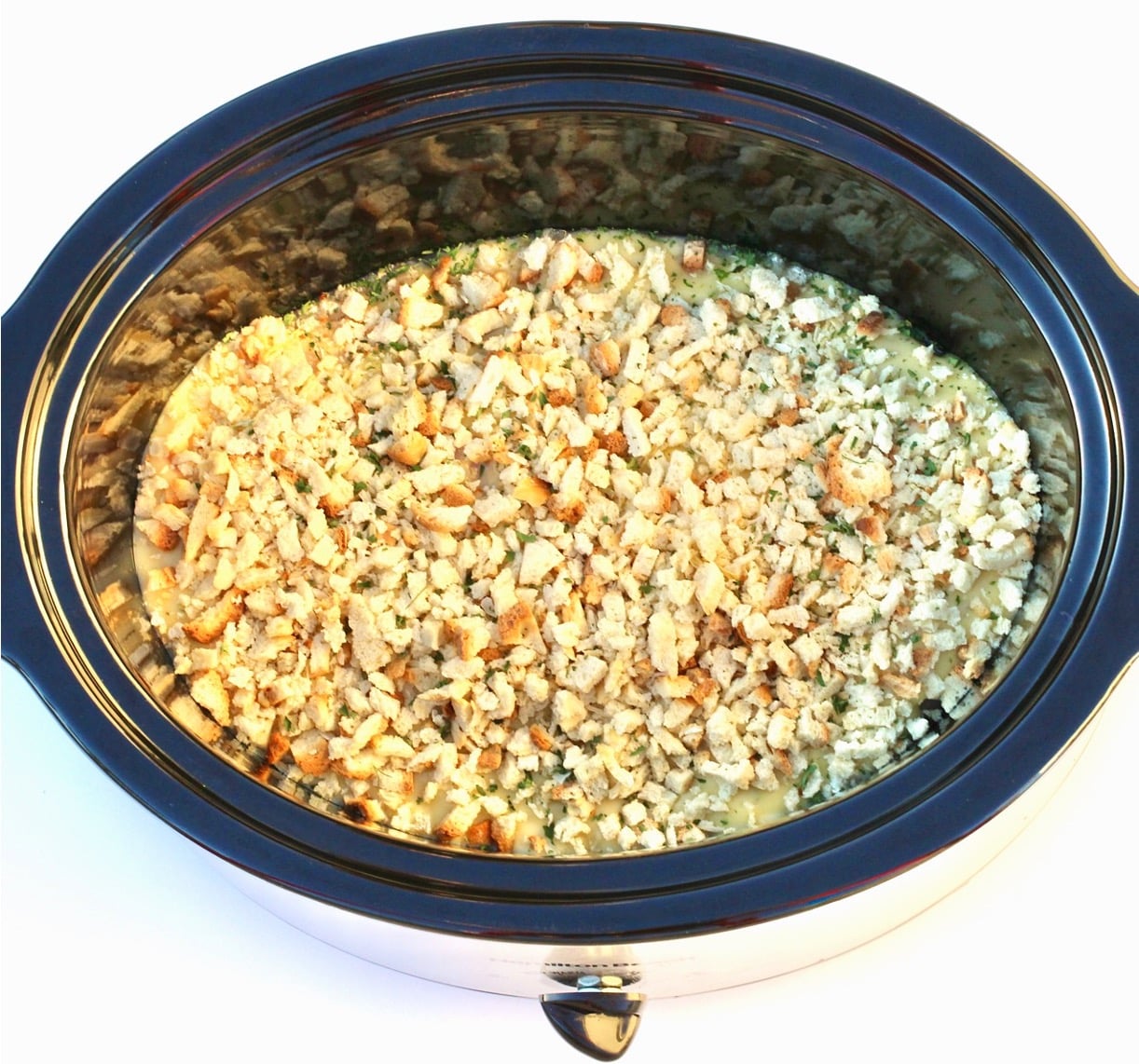 Chicken and stuffing casserole cooking in crockpot.
