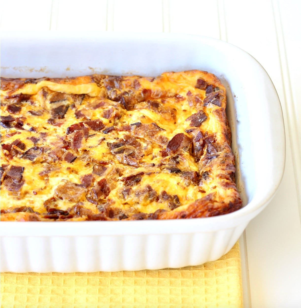 Egg casserole with bacon and cheese in 9x13 baking dish.