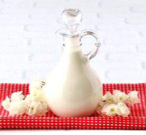 Homemade coffee creamer in small pour spout glass container.