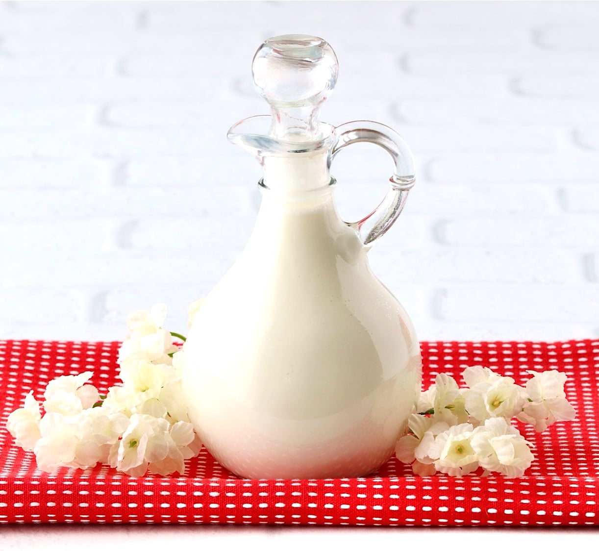 Homemade coffee creamer in small pour spout glass container.