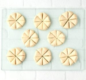 Biscuit dough each cut into eight pieces for dumplings.