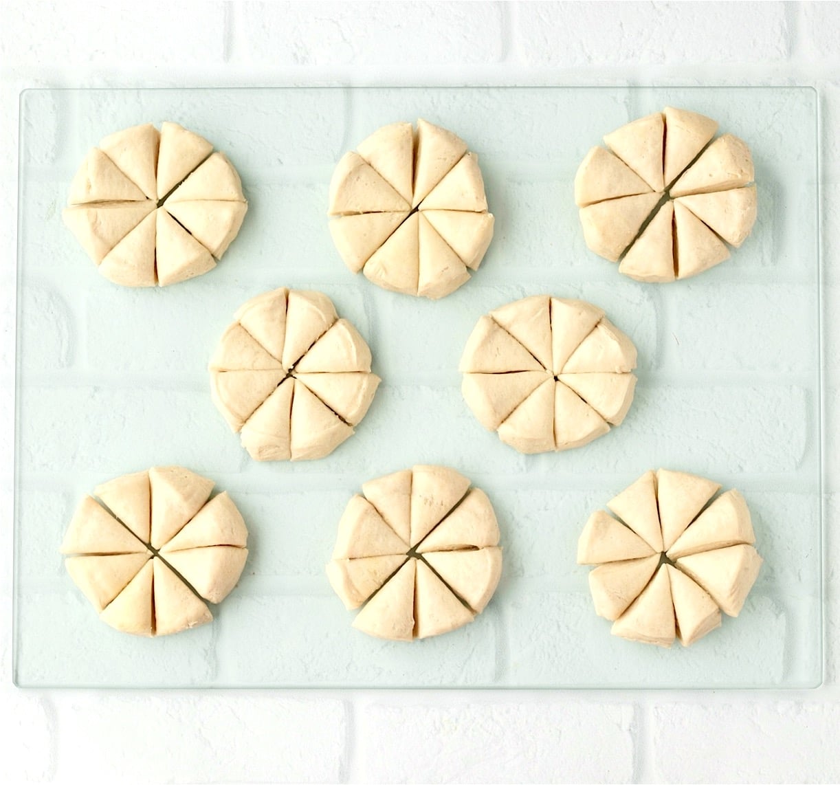 Biscuit dough each cut into eight pieces for dumplings.