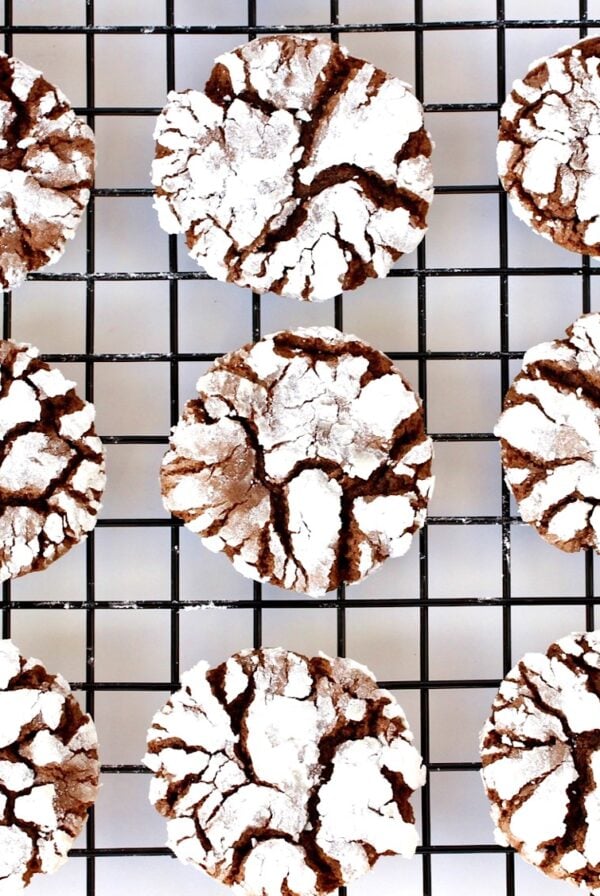 Chocolate crinkle cookies cooling on baking sheet.