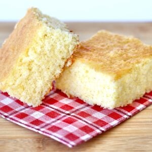 Two pieces of cornbread on napkin.