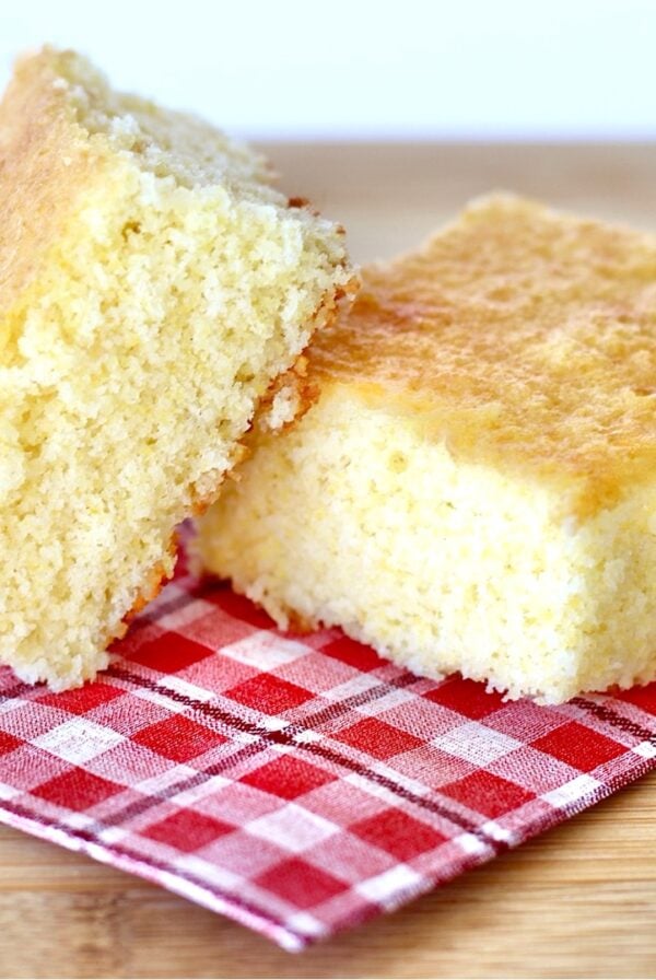 Two pieces of cornbread on napkin.