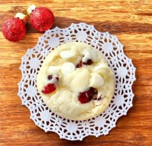 Cranberry white chocolate cookie on cutting board.