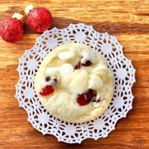 Cranberry white chocolate cookie on cutting board.