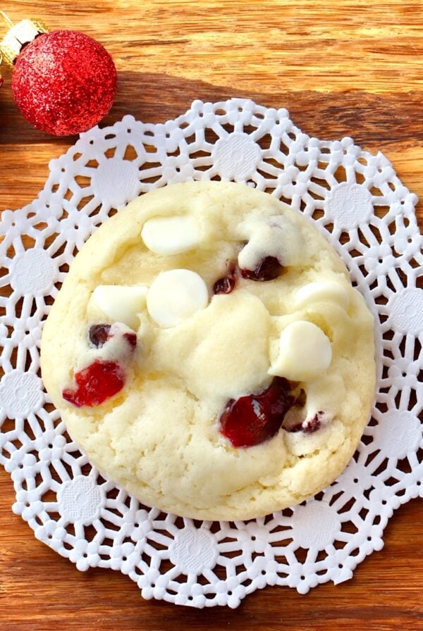 Cranberry white chocolate cookie on cutting board.