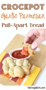 Hand holding piece of garlic parmesan pull apart bread.