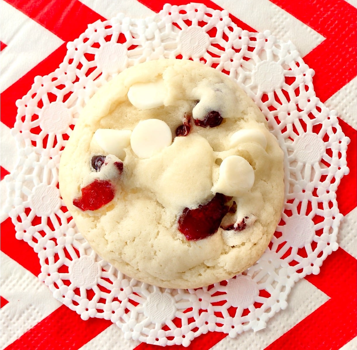 White chocolate chip cranberry cookie on napkin.