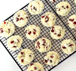 White chocolate cranberry cookies cooling on baking rack.