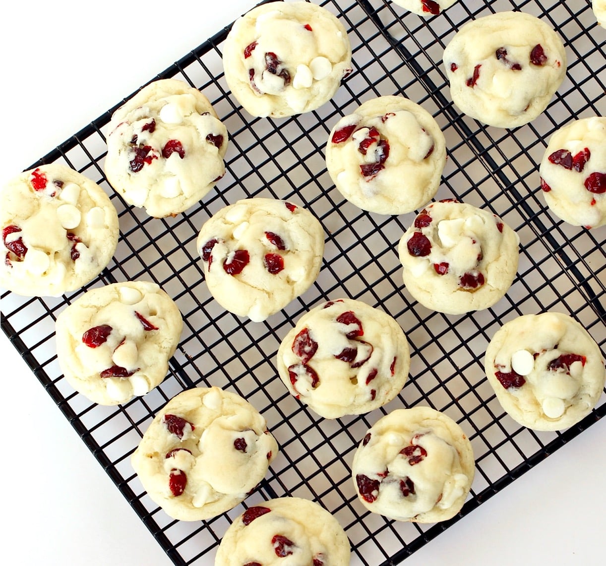 White chocolate cranberry cookies cooling on baking rack.